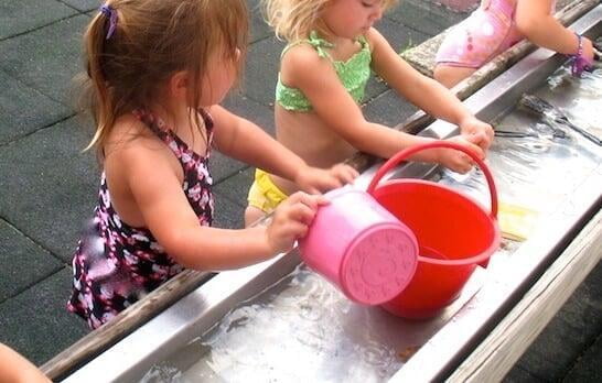 Children playing at a water table
